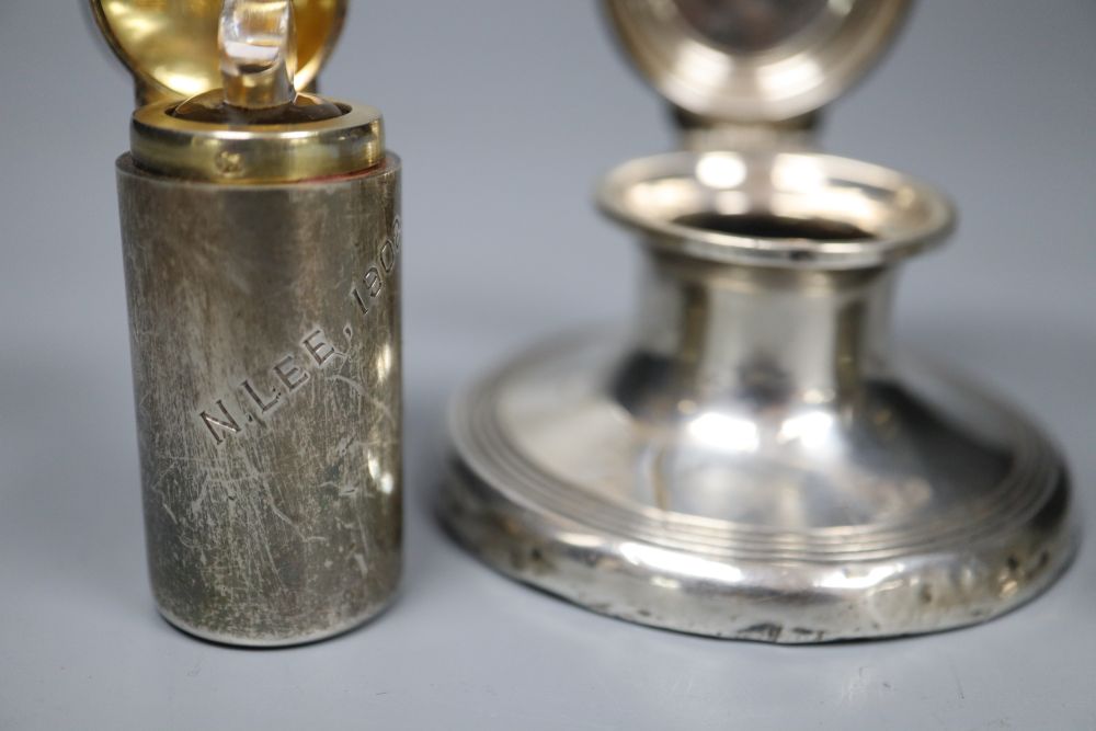 A silver capstan inkwell and two silver-cased cylindrical scent bottles